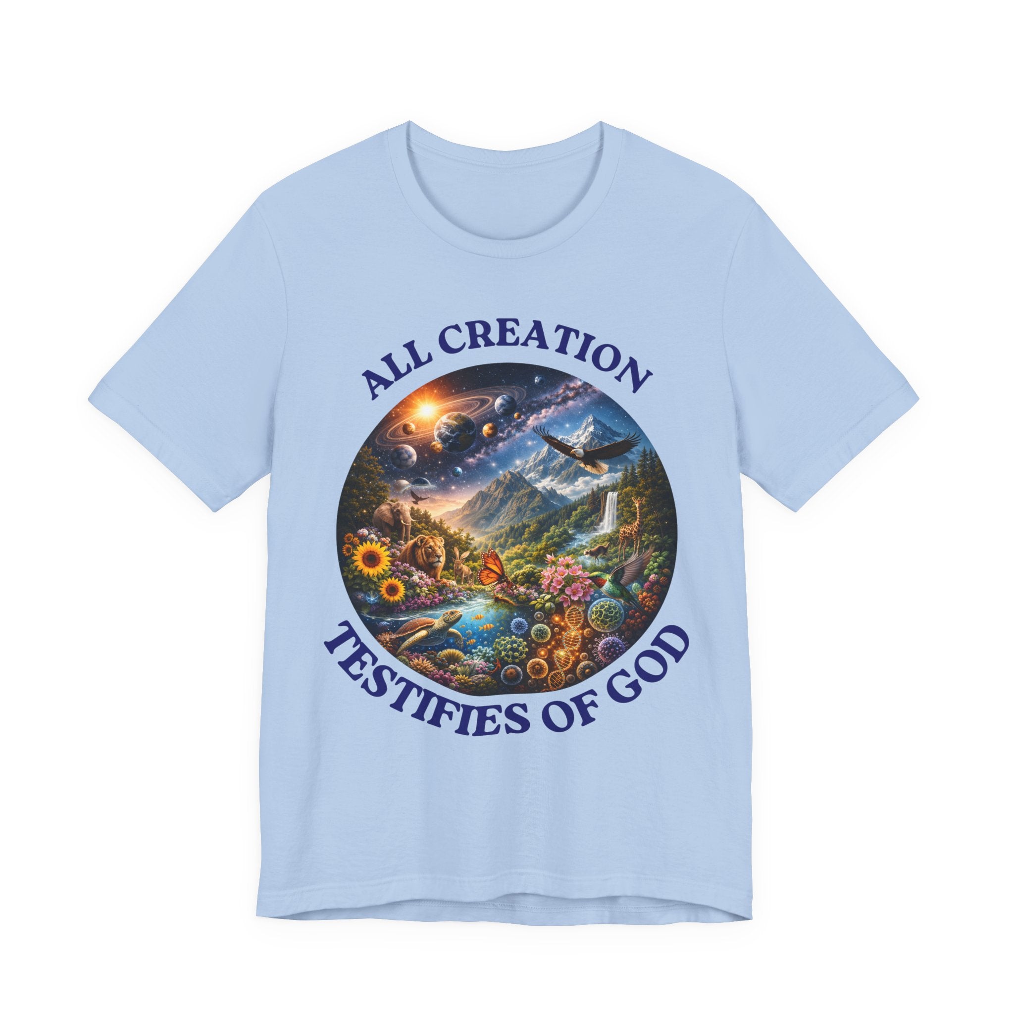 A light blue short-sleeve crewneck t-shirt featuring a circular graphic print in the center with a colorful landscape and the text 'ALL CREATION TESTIFIES OF GOD' in dark blue around the border.