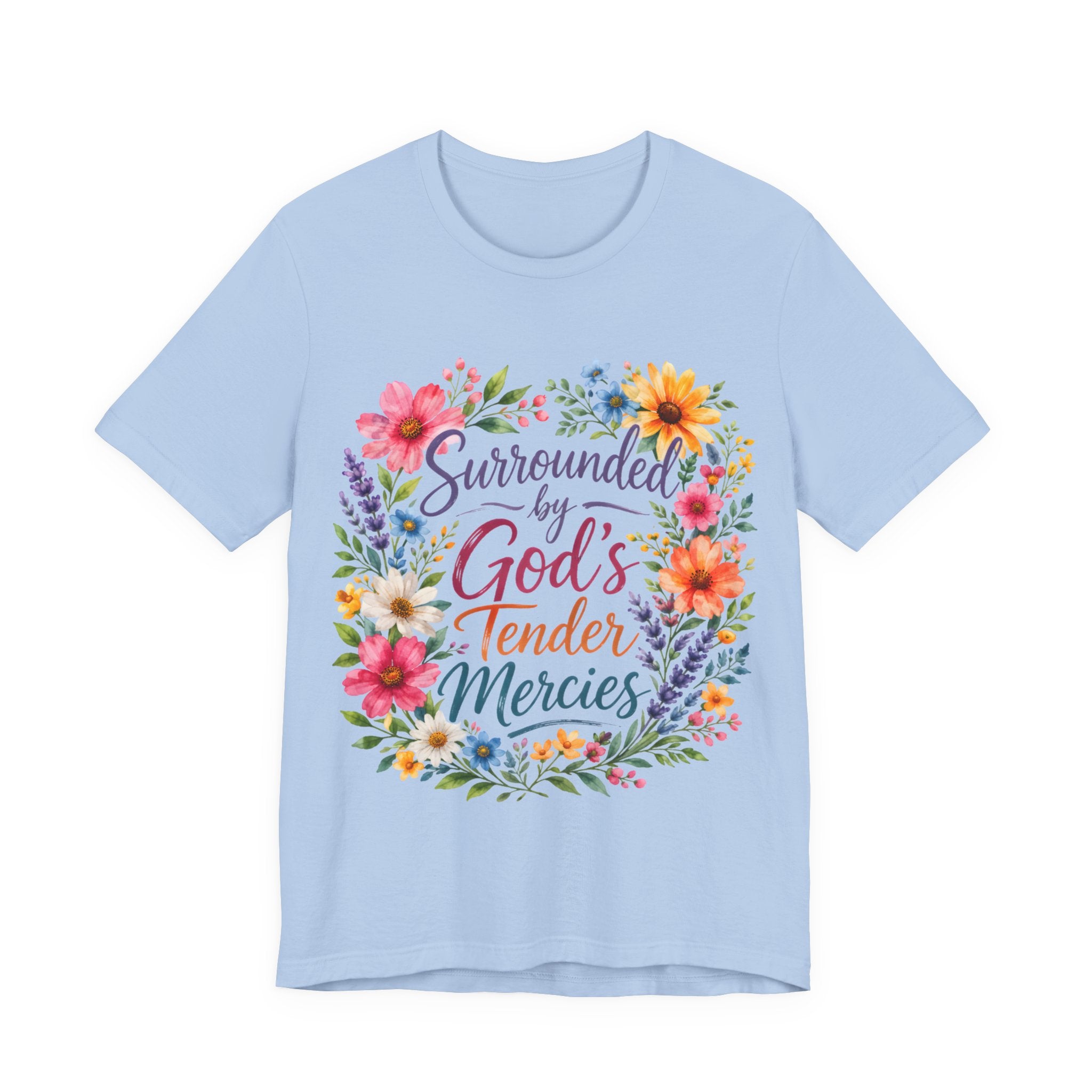 Baby Blue t-shirt with colorful floral design and text 'Surrounded by God's Tender Mercies' on a white background