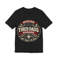Black t-shirt with 'Tired Dads Garage' graphic design.