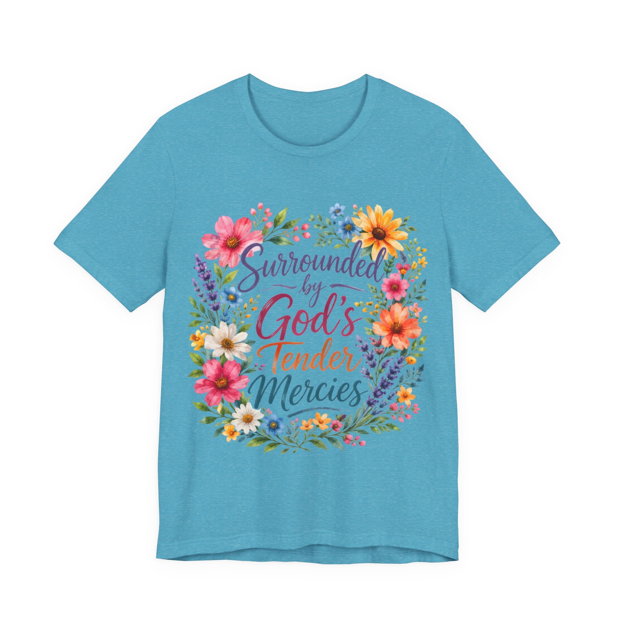 Heather Aqua t-shirt with colorful floral design and text 'Surrounded by God's Tender Mercies' on a white background