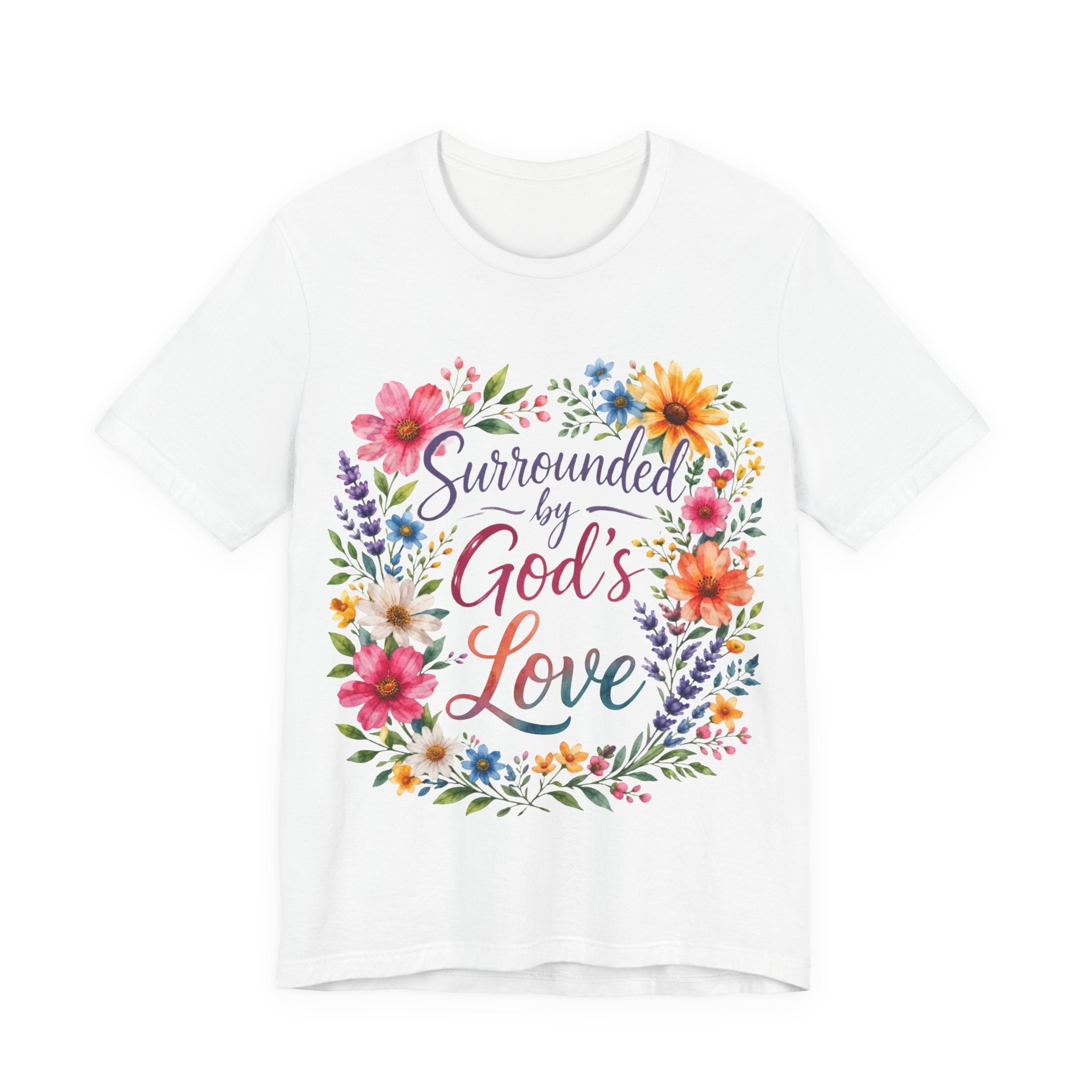 White t-shirt with colorful floral design and text 'Surrounded by God's Love' on a white background