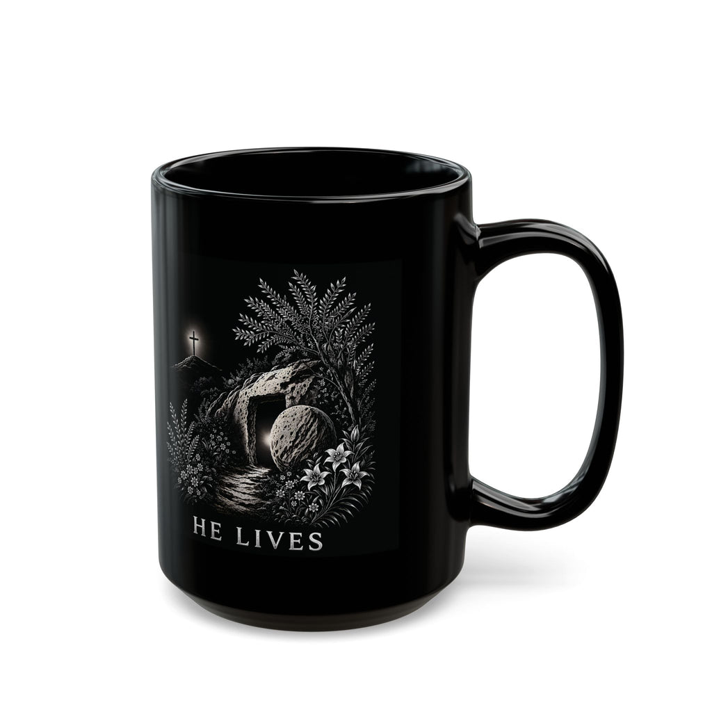 Black mug with religious design and 'HE LIVES' text on a white background